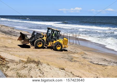 VILANO BEACH, FLORIDA, USA -  OCTOBER 19, 2016: Heavy construction equipment clearing beach debris caused by hurricane Matthew hitting the east coast of Florida on October 7, 2016.