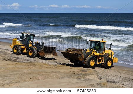 VILANO BEACH, FLORIDA, USA - OCTOBER 19, 2016: Heavy  construction equipment clearing beach debris caused by hurricane Matthew hitting the east coast of Florida on October 7, 2016.