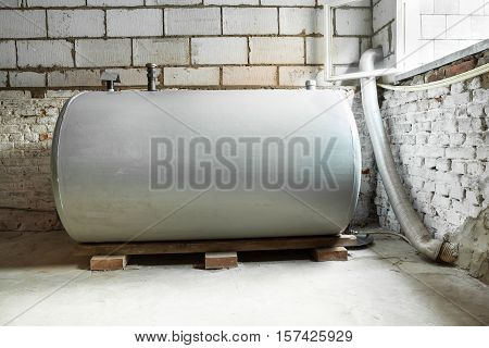 in a separate room in a old building there is a heating oil tank