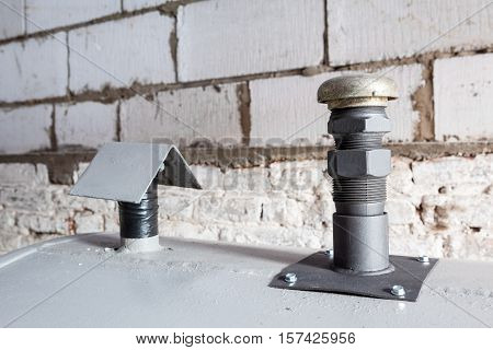 in a separate room in a old building there is a heating oil tank