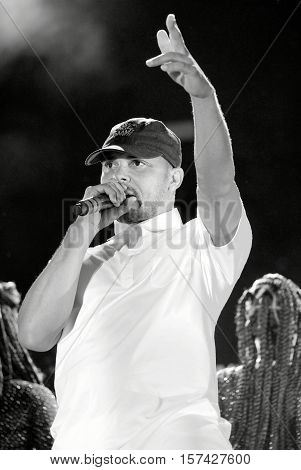 NEWPORT, ISLE OF WIGHT, UK - SEPTEMBER 9 2016:   Leighton Walsh aka Walshy Fire  performing on stage with Major Lazer at Bestival festival on the Isle of Wight