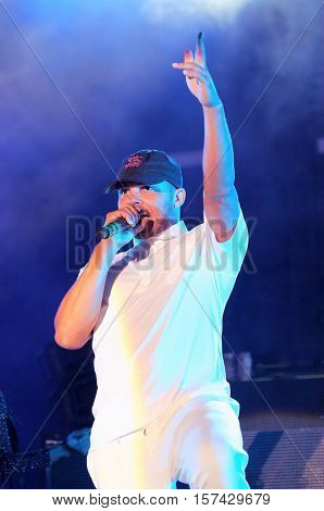 NEWPORT, ISLE OF WIGHT, UK - SEPTEMBER 9 2016:   Leighton Walsh aka Walshy Fire  performing on stage with Major Lazer at Bestival festival on the Isle of Wight