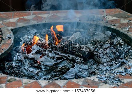 Burning paper with ashes, ember and flame