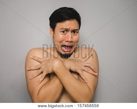 Topless Asian man with funny act of shy and shocked.