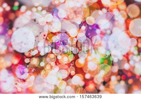 background with natural bokeh defocused sparkling lights. Colorful metallic texture with twinkling lights. Bright and vivid colors