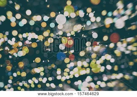 background with natural bokeh defocused sparkling lights. Colorful metallic texture with twinkling lights. Bright and vivid colors