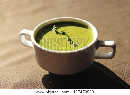 green cream soup of celery in white dishes