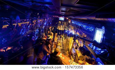 PRAGUE - MAY 16, 2014: Young people order the drinks on the bar of the underground night club Cross built in style of steam punk on May 16, 2014. Prague receives more than 4.4 million visitors annually