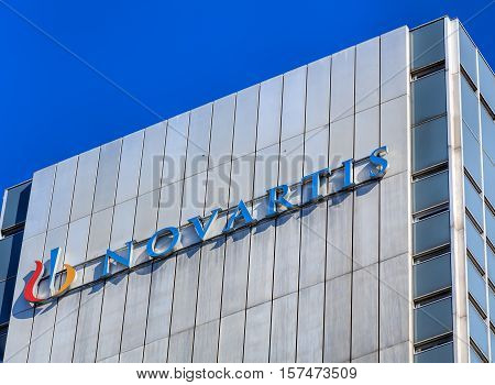 Basel, Switzerland - 27 August, 2016: upper part of one of Novartis buildings, view from Dreirosenbruecke bridge. Novartis International AG is a Swiss pharmaceutical company based in Basel.
