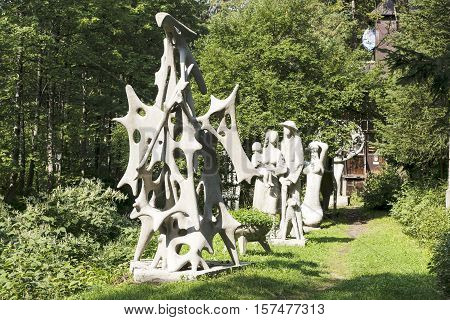 ZAKOPANE POLAND - SEPTEMBER 15 2016: Exhibition of outdoor sculptures placed among the greenery in front of a studio. All those sculptures are by artist Henry Burzec who was born 1919 died 2005
