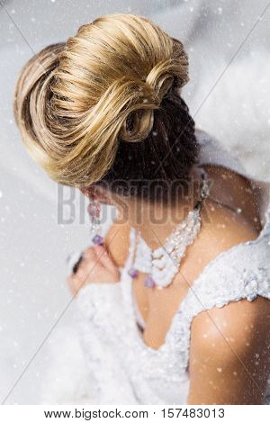 Close-up of beautiful wedding babette hairdo. Blonde bride. Copy space.