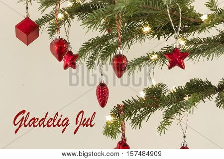 Red christmas ornament on a green tree