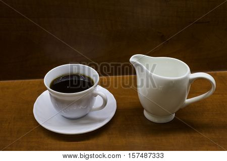 Porcelan cup of coffee on the brown table