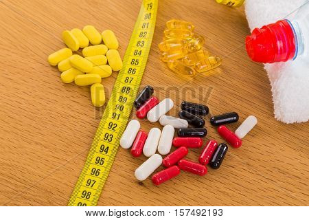 Diet pills on the table. Beautiful figure.