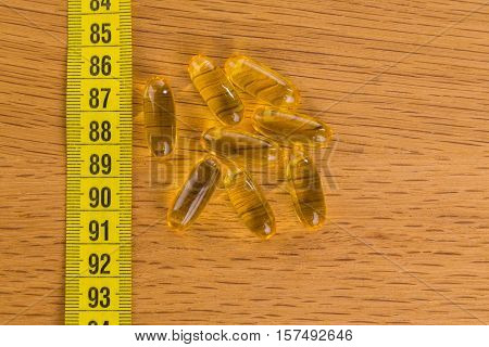 Diet pills on the table. Beautiful figure.