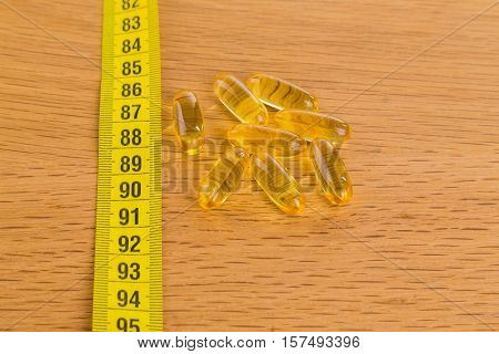 Diet pills on the table. Beautiful figure.