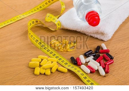 Diet pills on the table. Beautiful figure.