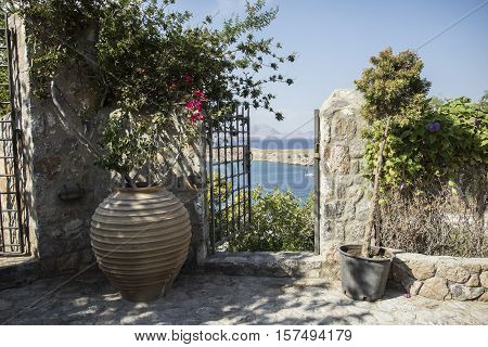 beautiful view of the old courtyard on the Greek bay with yacht
