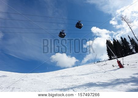 Jasna resort LIPTOV SLOVAKIA - March 31 2016: Blue sky and two cabins of new modern lift Funitel on the Jasna ski resort Low Tatras Slovakia.