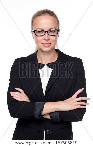 Portrait of beautiful young caucasian woman in business attire wearin black eyeglasses standing with arms crossed against white background.