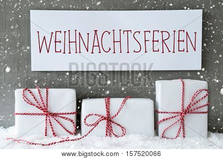 Label With German Text Frohe Weihnachten Means Merry Christmas. Three Christmas Gifts Or Presents On Snow. Cement Wall As Background With Snowflakes. Modern And Urban Style.