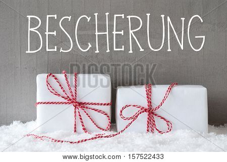 German Text Bescherung Means Gift Giving. Two White Christmas Gifts Or Presents On Snow. Cement Wall As Background. Modern And Urban Style.