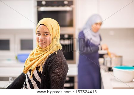Group of Muslim women in kitchen making food