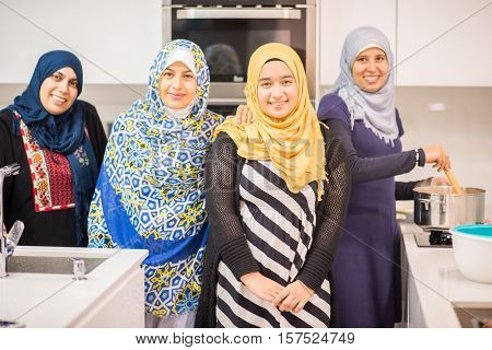 Group of Muslim women in kitchen making food