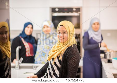 Group of Muslim women in kitchen making food
