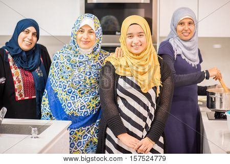 Group of Muslim women in kitchen making food