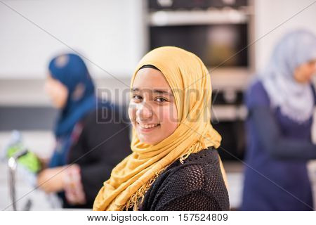 Group of Muslim women in kitchen making food