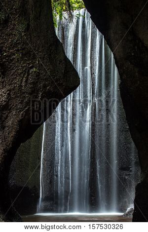 Beautiful secret Tukad Cepung Waterfall in Bali, Indonesia. Long exposure shot