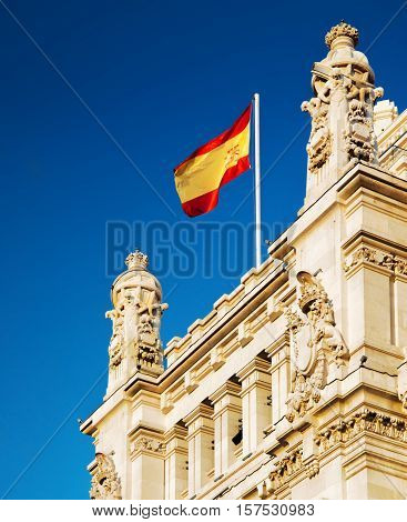 The Flag Of Spain Fluttering On The Cybele Palace In Madrid