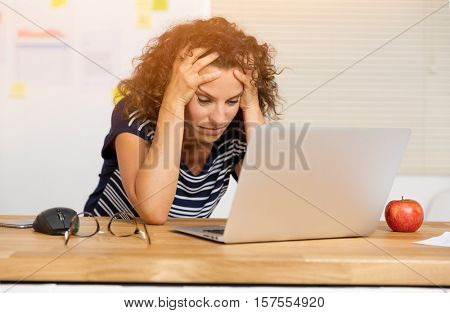 Middle age woman felling exausted at the office
