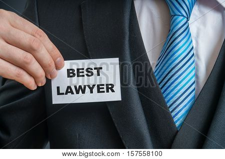 Self-confident Man In Suit Is Showing Label That He Is The Best