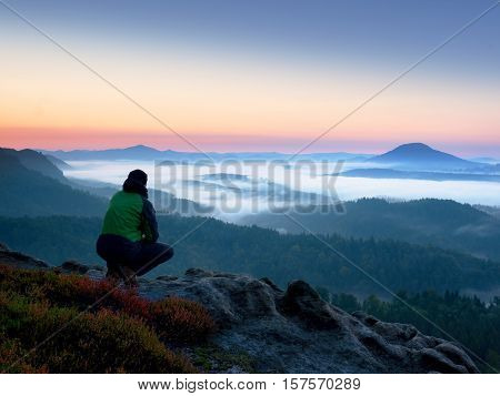 Hiker  Man On Rock Watch Over Creamy Mista And Foggy Morning Landscape.