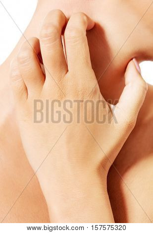 Topless woman scratching her neck.