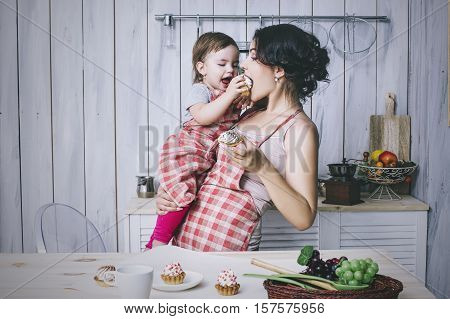 Mother And Small Child In The Kitchen At Home Beautiful And Happy