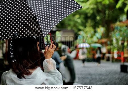 Take Photo The Activities Merit Of Her Friends In Rain.