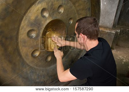 Big gong in a buddist temple where you could see how clean is your karma Thailand