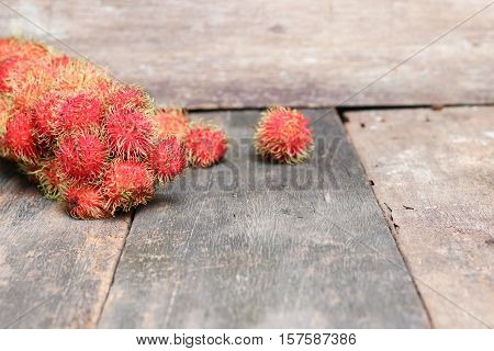 rambutan sweet fruit fresh on wood background :Select focus with shallow depth of field.