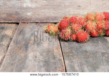rambutan sweet fruit fresh on wood background : Select focus with shallow depth of field.