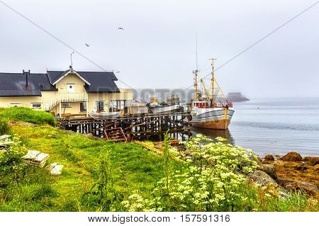 Small traditional fishing boat stands moored in Northern Norway.