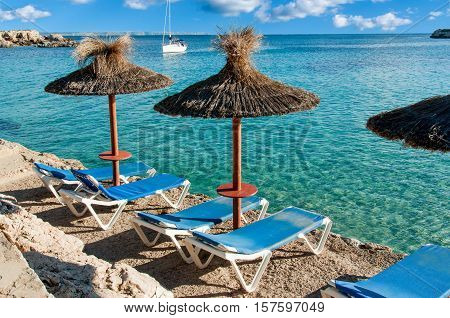 Beautiful seascape with yacht and sun umbrellas. Spain Majorca