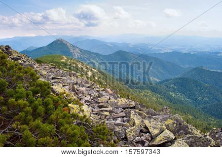 Carpathian mountains in autumn. Stone field on the way to Mount Homiak. Cloudy sunny day