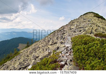 Path through the stone field to the mountain peak