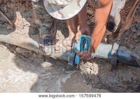 Workers repair leg stomp on Plumbing broken to hole fix water leak at big on the road