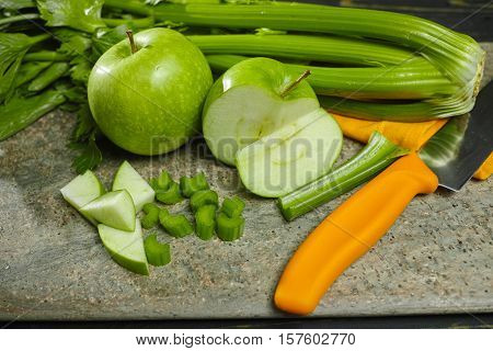 Green vegetables and fruits - celery shoots and apples healthy fitness diet concept