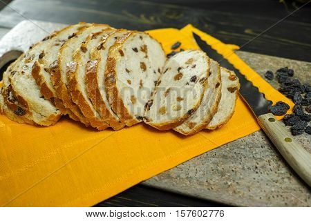 Fresh baked raisins bread sliced on granite board
