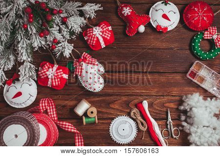 felt Christmas decorations on the wooden table - preparing for handmade